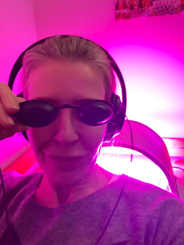 Woman wearing headphones and blackout goggles