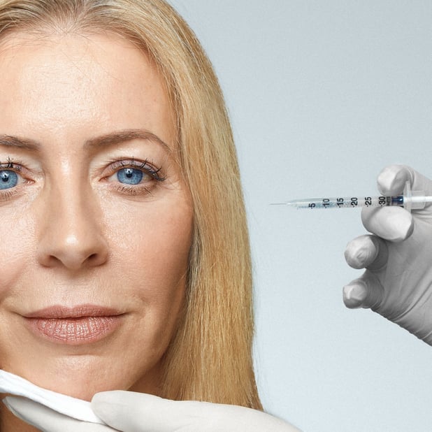 Write Alice Hart-Davis next to a gloved hand holding a needle ready to inject botox 