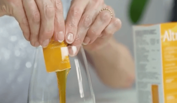 Altrient vitamin C being squeezed into a glass 