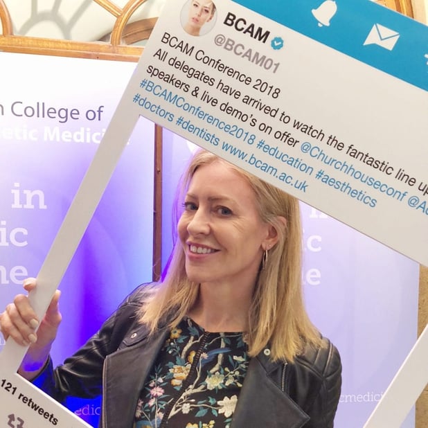 Alice Hart-Davis holding up a social media board at the BCAM conference 